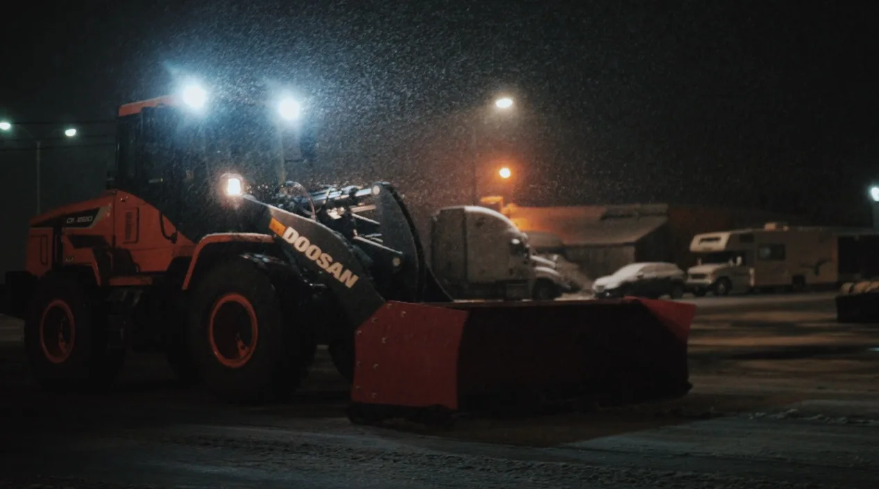 Heavy Machinery Removing Snow From a Parking Lot
